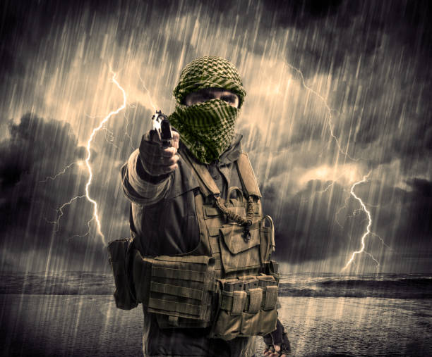 istock Dangerous armed terrorist with mask and gun in a thunderstorm with lightning 1328450319