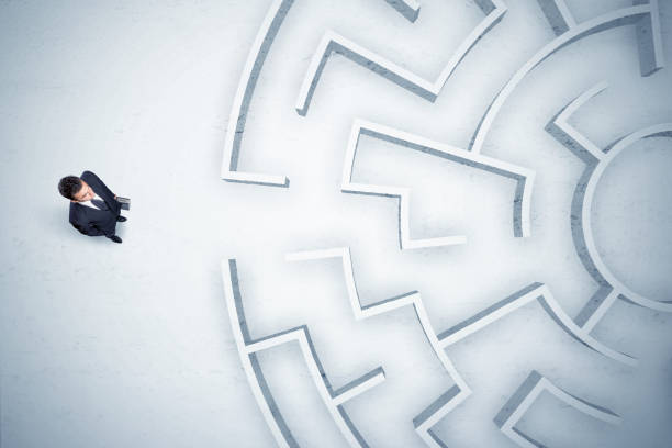istock Business man looking at circular maze with nowhere to go 1328450369