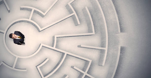 istock Business man trapped in a circular maze 1328450378