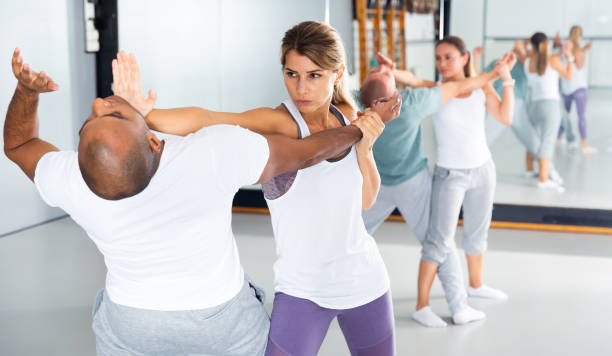 istock Girl using palm to launch blow in chin during self defence training 1328450424