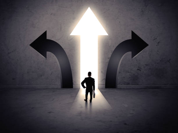 istock Businessman in front of three arrows 1328450698