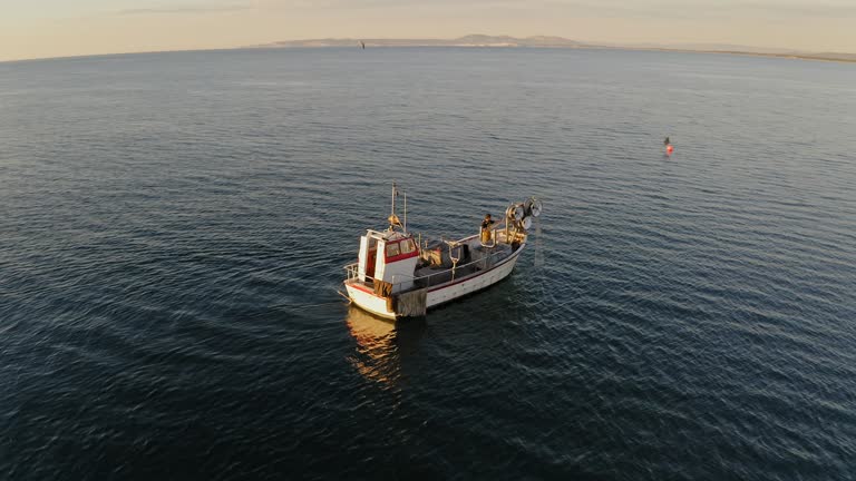 Independent Fisherman Managing Trawl Net on Fishing Boat