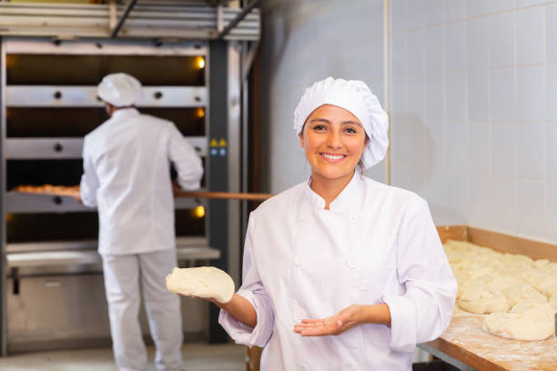 istock Woman baker demonstrates ready dough for baking in oven 1328451739