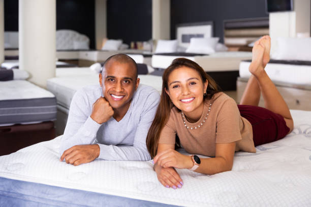 istock Couple lying on new mattress in store 1328451794