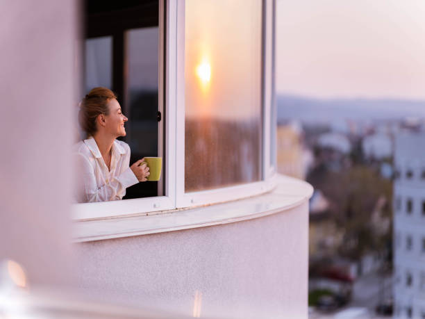 istock Happy woman day dreaming during coffee time on a window. 1328451810