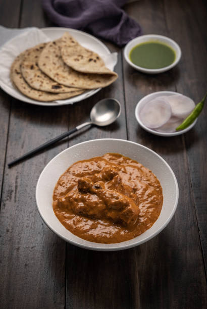 istock chicken butter masala served with lachha parantha 1328452127