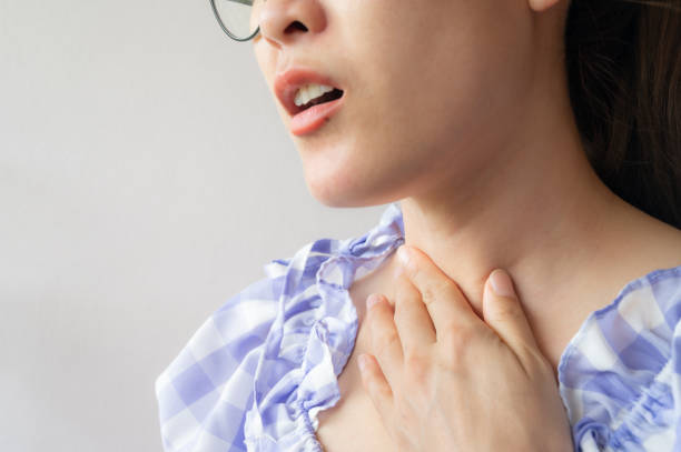 istock Close up of woman coughing while she having sore throat problem. 1328453463