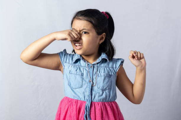 facial expressions child A pretty cute Indian girl child shows bad smell holding her nose isolated on white background holding nose stock pictures, royalty-free photos & images