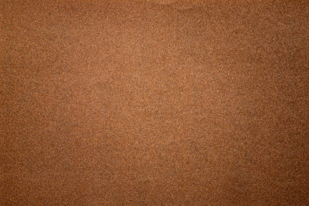 istock Sandpaper texture background where you can see the red-brown sand grain pattern on the sandpaper, suitable as a background for inserting text. Copy Space for designers to use on sandpaper. 1328454569