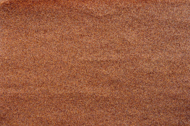 istock Sandpaper texture background where you can see the red-brown sand grain pattern on the sandpaper, suitable as a background for inserting text. Copy Space for designers to use on sandpaper. 1328454607