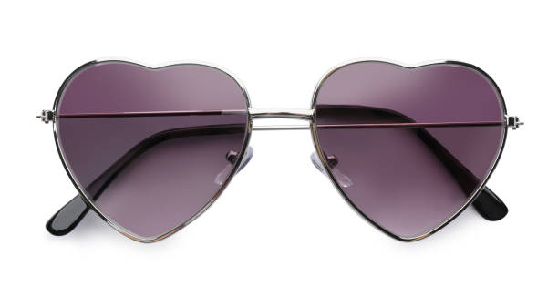 istock Stylish heart shaped sunglasses on white background, top view. Beach object 1328457313