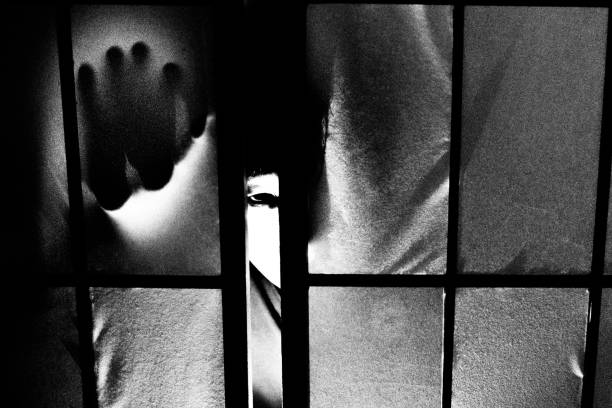 istock Creepy man's eyes peeking through a shoji 1328458485