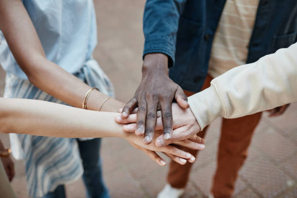 istock Group of Friends Stacking Hands Closeup 1328460695