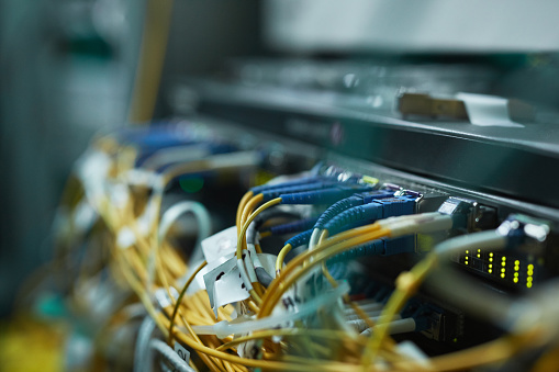 Close up background image of blade servers in server cabinet at supercomputer or data center, copy space