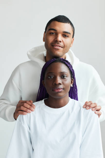 istock Smiling Young Couple in White 1328462448