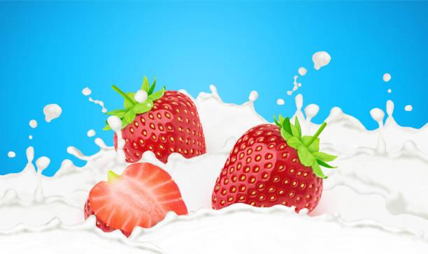 istock Strawberry in milk splashes isolated on a blue background. 1328463037