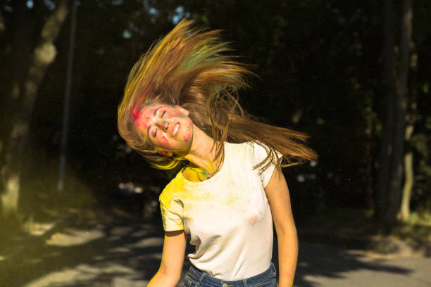 istock Attractive blonde girl with wind in hair and vibrant colors exploding around her 1328463881