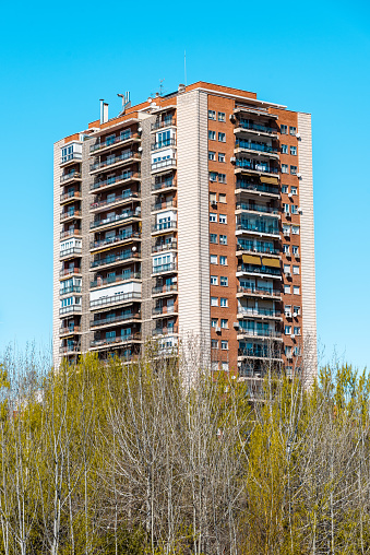Apartment Building against blue sky. Madrid, Latina District. Real estate and residential market concepts