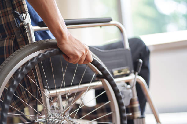 istock Hands of elderly people in wheelchairs 1328465258