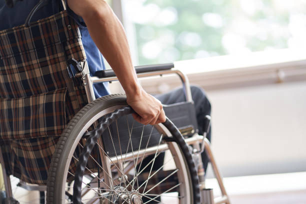 istock Hands of elderly people in wheelchairs 1328465266