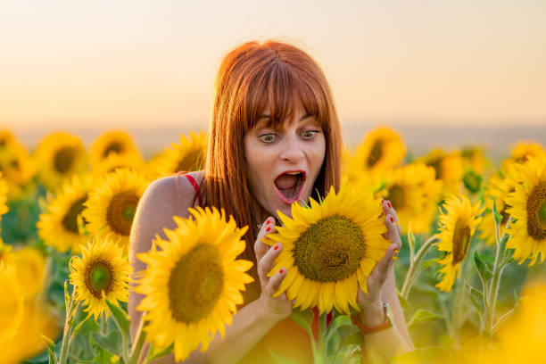 istock Expressive Woman in Sunflower Field 1328465599