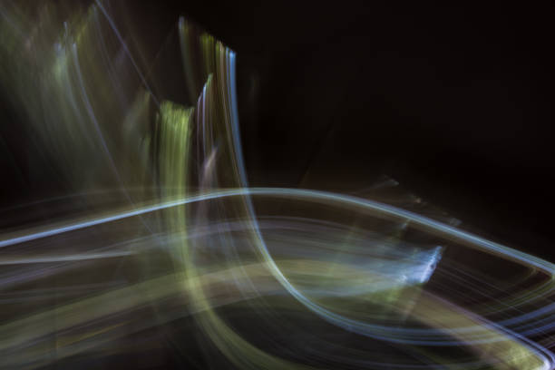 istock Abstract illustration with light from multi-colored curved lines on a black background. Photo effect. 1328467024