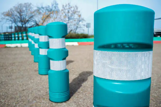 Green plastic bollards with reflective tape. Selective focus