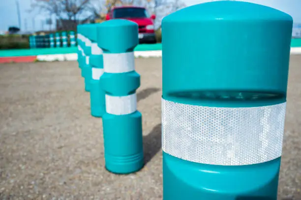 Green plastic bollards with reflective tape. Selective focus