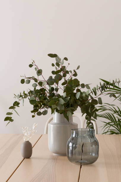 istock Elegant vase with eucalyptus twigs on wooden table 1328468121