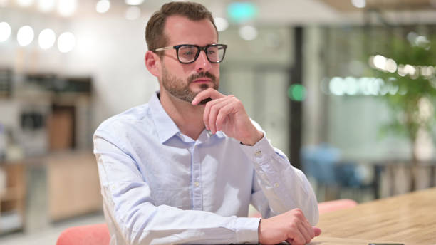 istock Businessman Sitting and Thinking in Office 1328471588