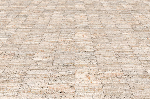 New paving made with italian travertine stone blocks of rectangular shape in a pedestrian zone