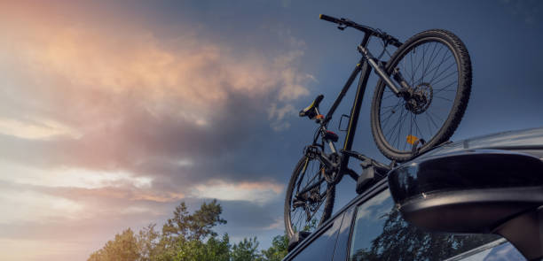 istock bicycle on the car roof rack against sunset sky. copy space 1328472921