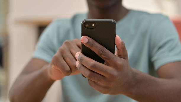 istock Close Up of African Man Using Smartphone 1328473250