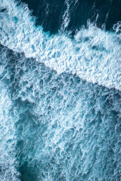 istock Big ocean waves hitting a coral reef. View from above. 1328473254