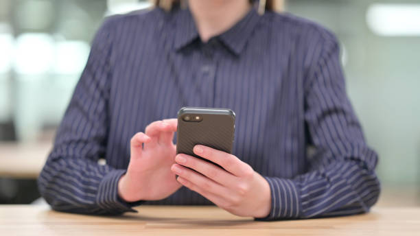 istock Close up of Businesswoman using Smartphone, Text Messaging 1328473309