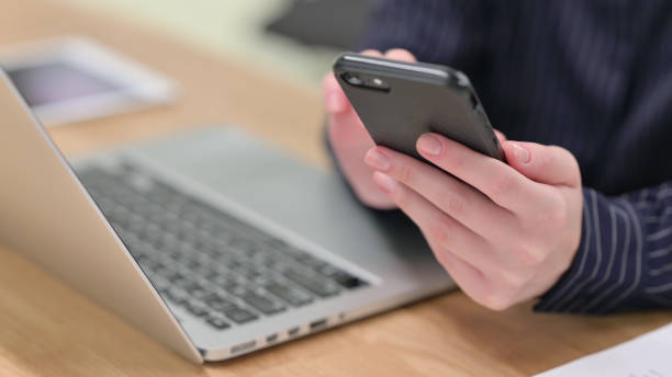 istock Top view of Female Hand Using Smartphone, Typing 1328473432