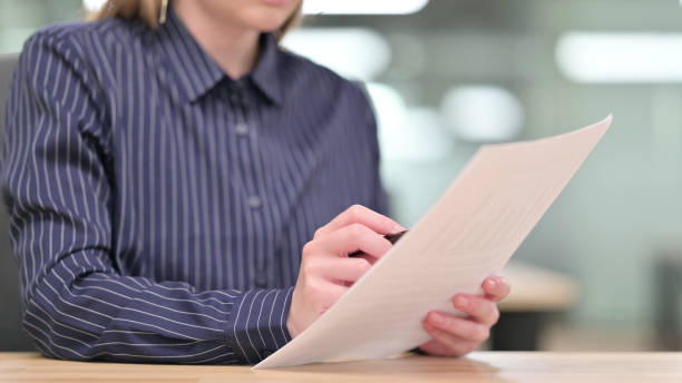 istock Close up of Businesswoman Reading Documents 1328473486