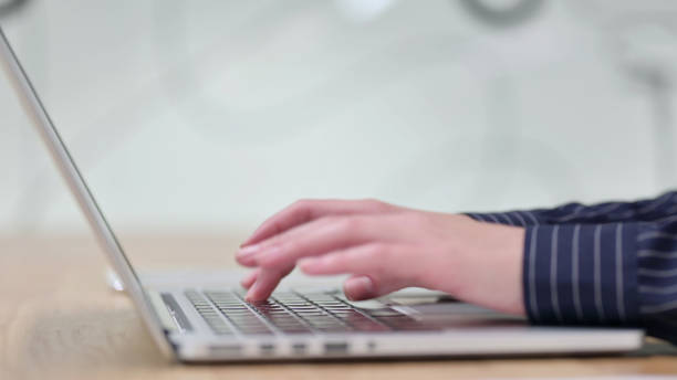 istock Side View of Woman Typing on Laptop 1328474523