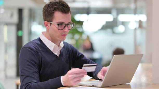 istock Online Payment on Laptop by Young Businessman 1328474589