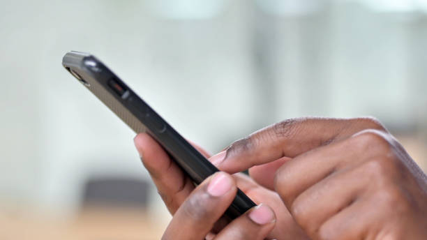 istock Close Up of African Man Using Smartphone 1328474608