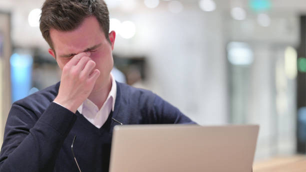 istock Young Businessman with Laptop having Headache 1328474779