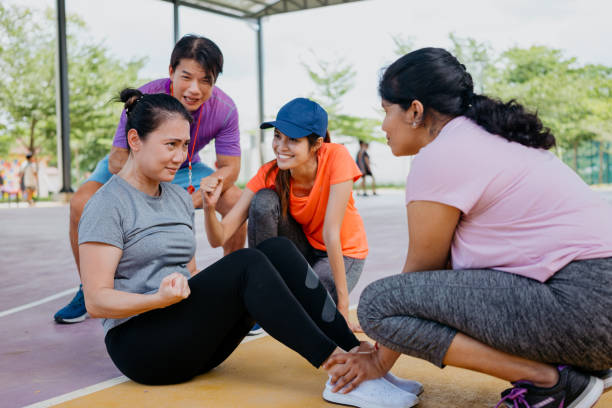 istock Asian woman doing sit-ups with friends 1328475081