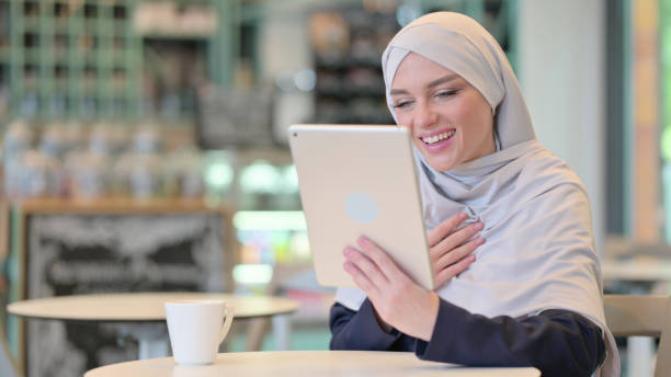istock Professional Young Arab Woman doing Video Call on Tablet 1328475209