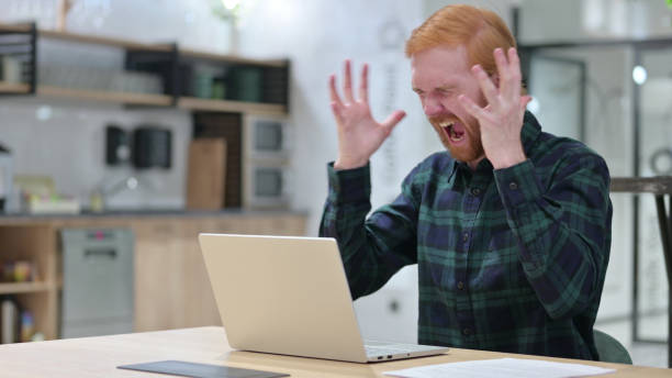 istock Redhead Man with Laptop Shouting, Screaming 1328475964
