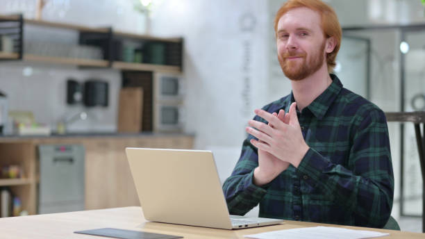 istock Redhead Man with Laptop Clapping, Applauding 1328476176