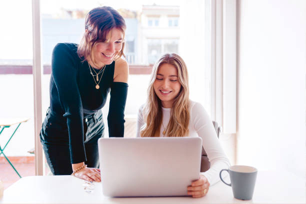 istock Two young women working with laptop at the office 1328476413