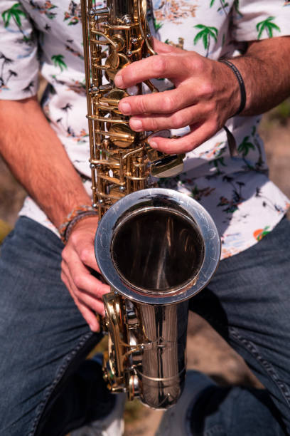 istock Musician playing saxophone outdoors 1328476515