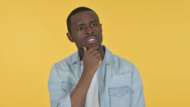 istock Young African Man Thinking Getting Idea, Yellow Background 1328477658