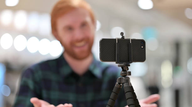 istock Creative Redhead Man Blogging on Smartphone 1328477881