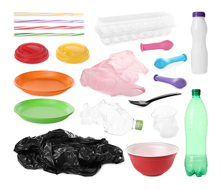 Set with different plastic items on white background